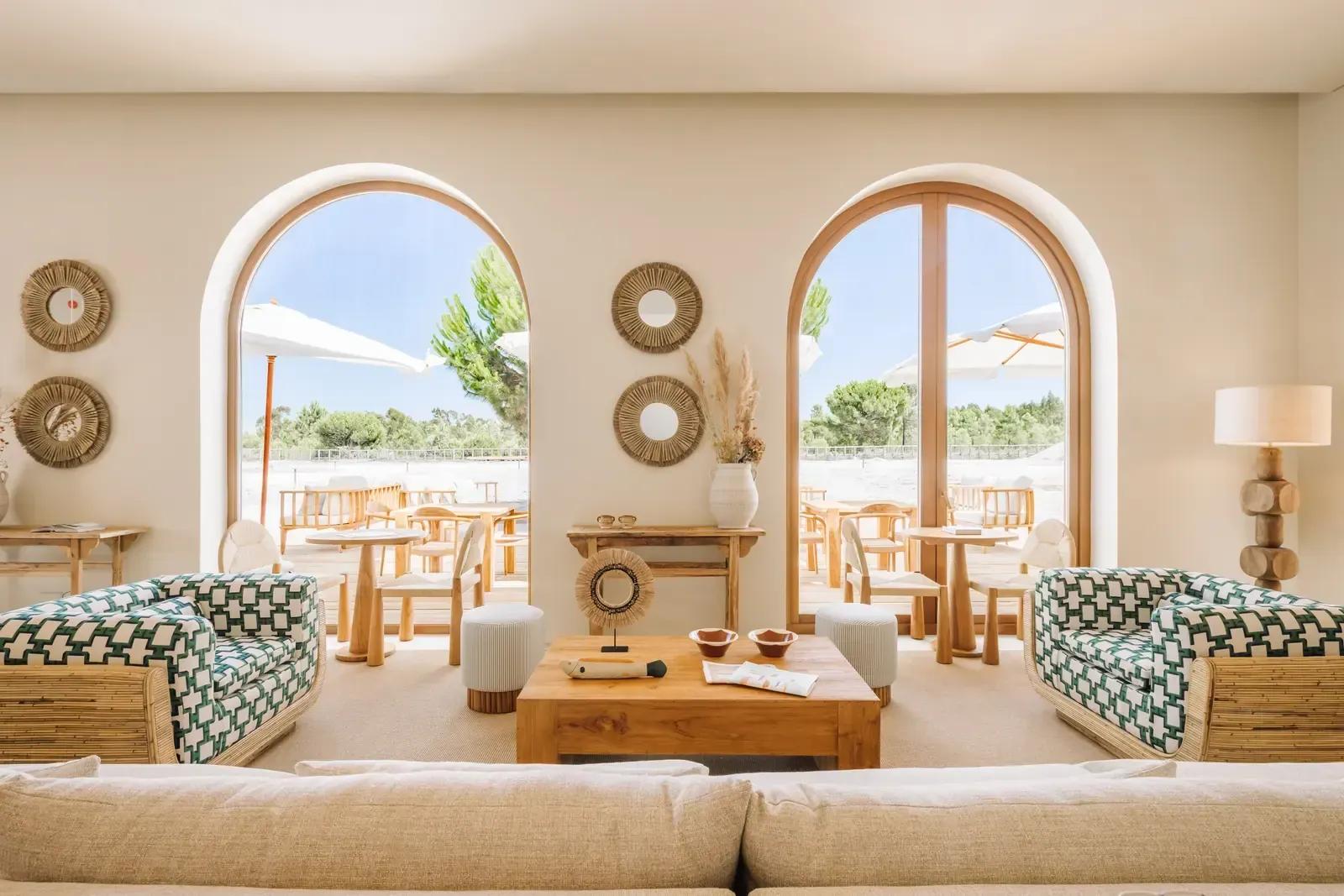 The House lounge, arched doors open to the terrace