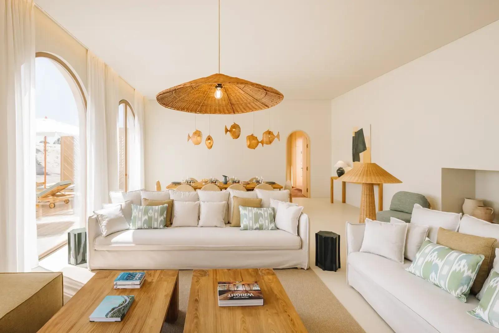 Living and dining room under a large woven pendant