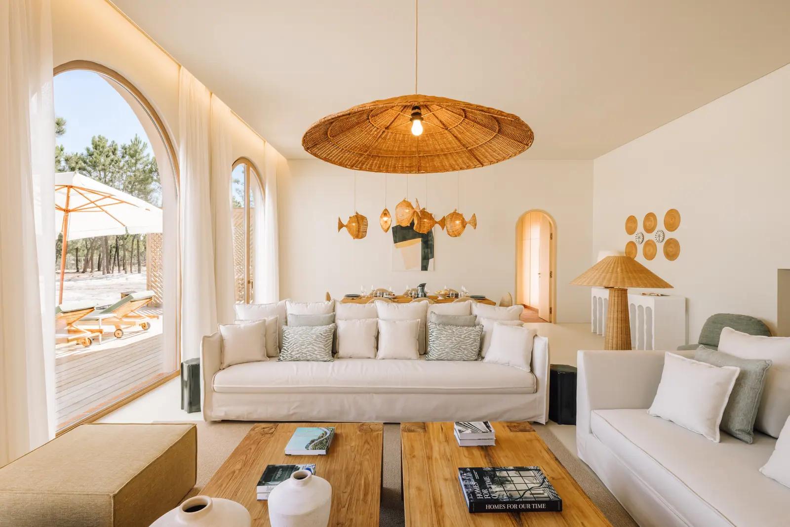Living room with tall arched windows onto the pines